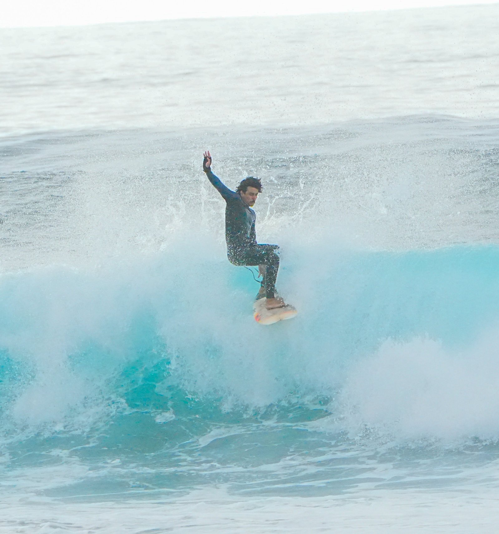 Surfer landing a floater on a clean head-high wave
