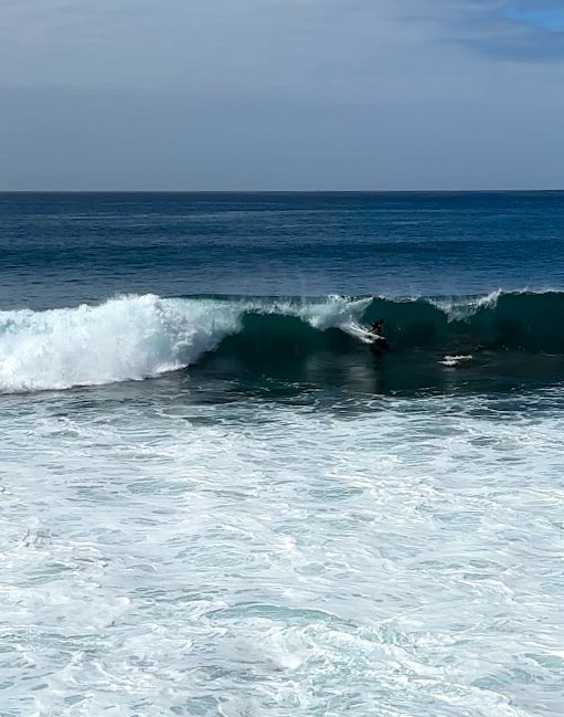 Local surfer catching an overhead wave and setting up for a barrel