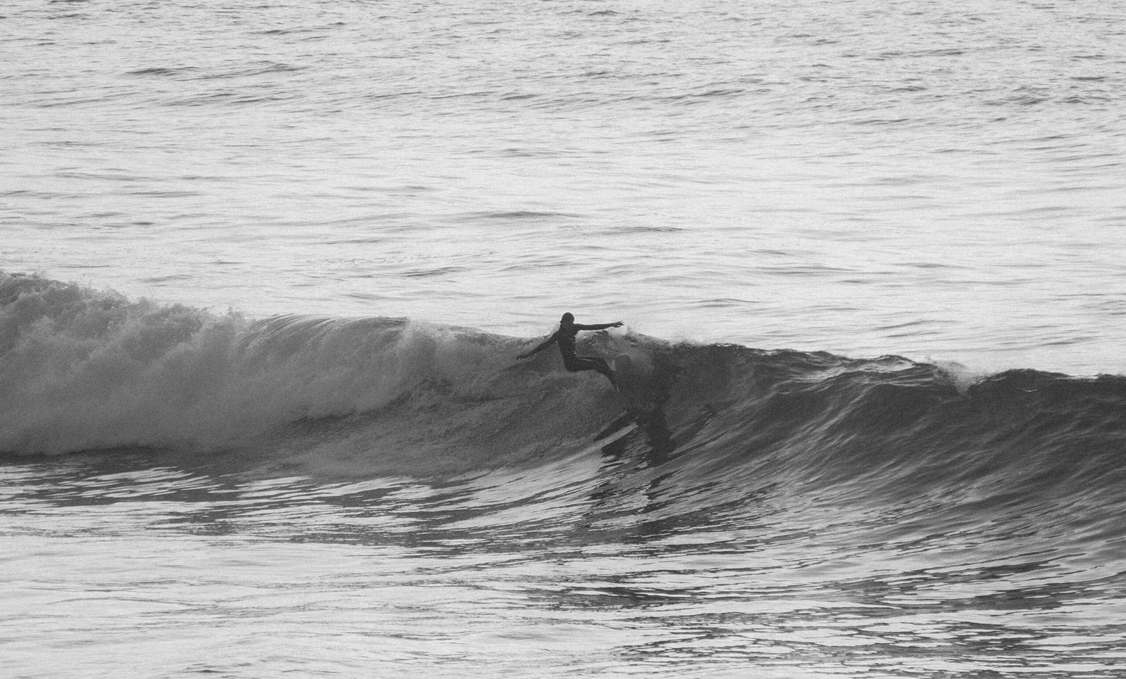 Intermediate surfer performing a snap on a clean head-high wave