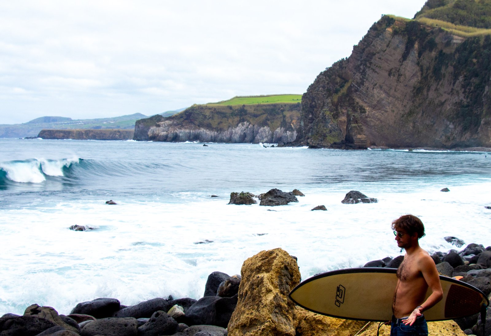 A surfer smiling at the wave in Santa Iria